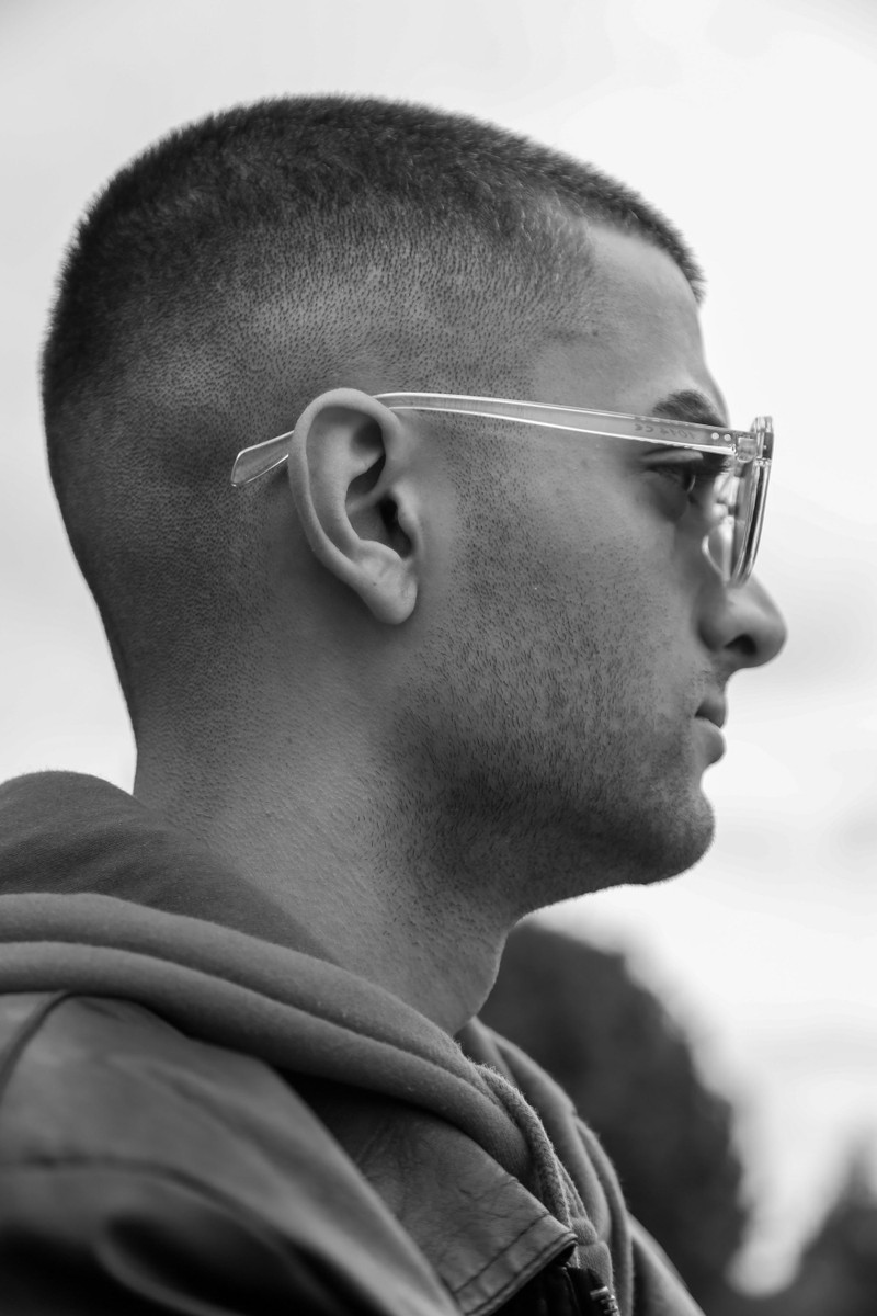 A man in sunglasses, black and white.