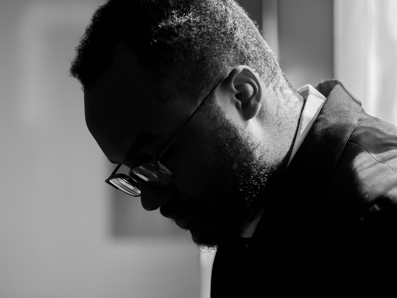 A man in glasses, close, black and white.