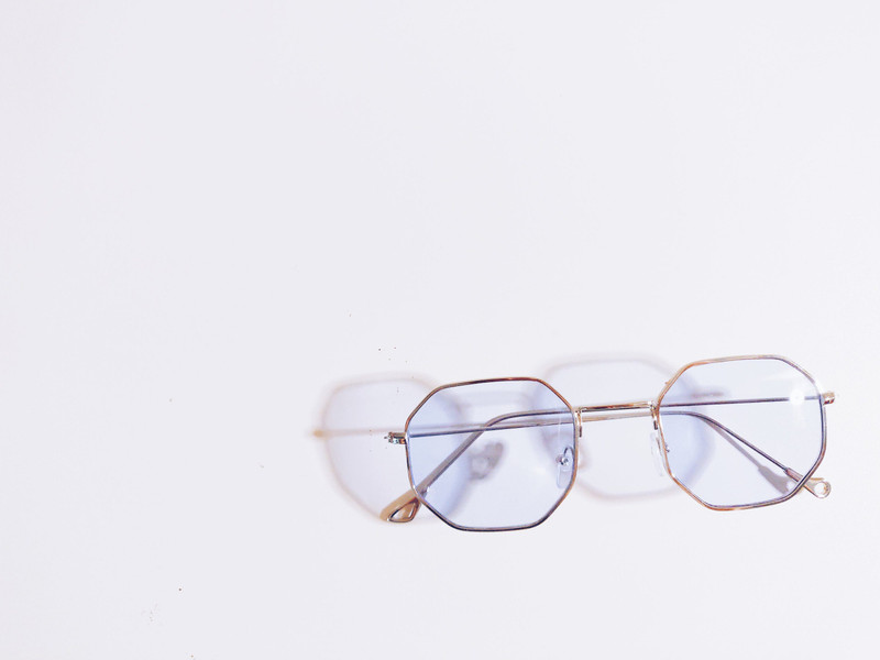 Hexagonal wire frames casting a shadow on white.