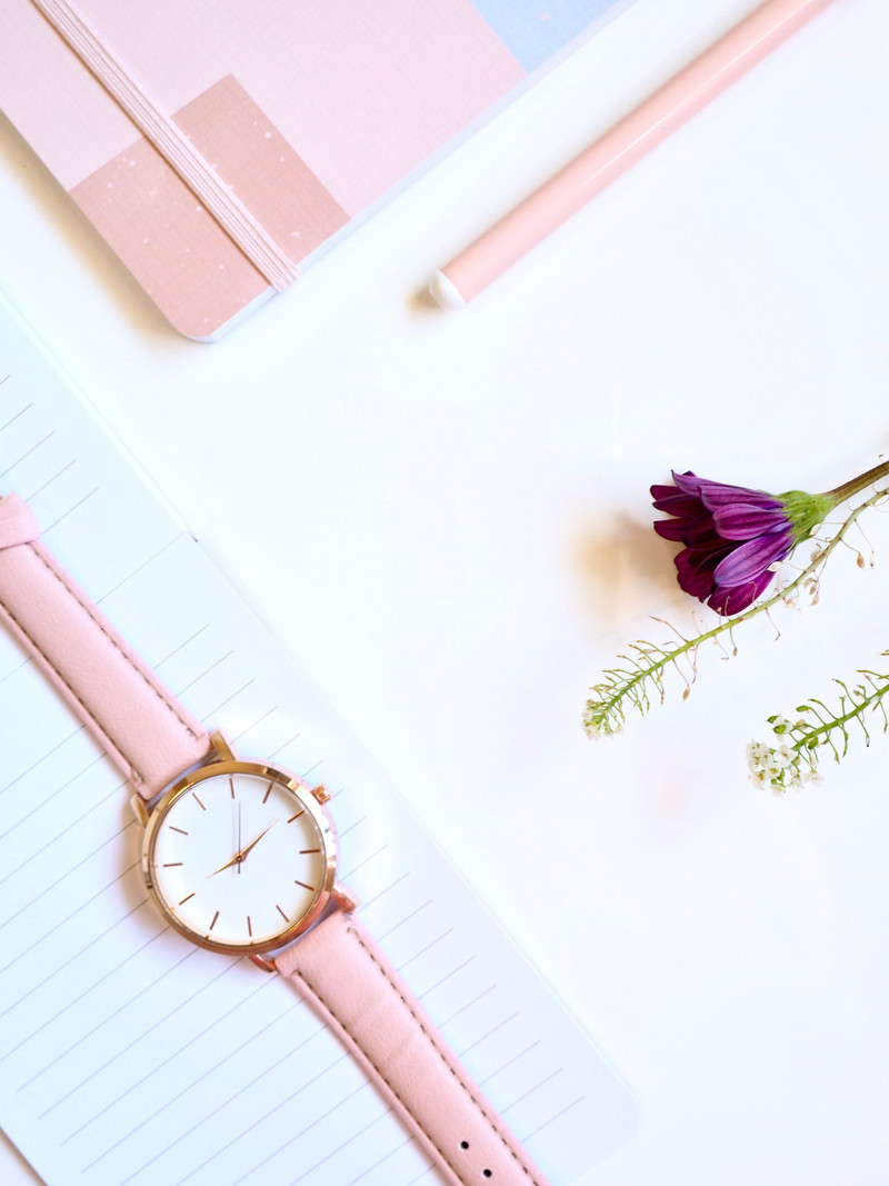 The rose gold watch with a purple flower.