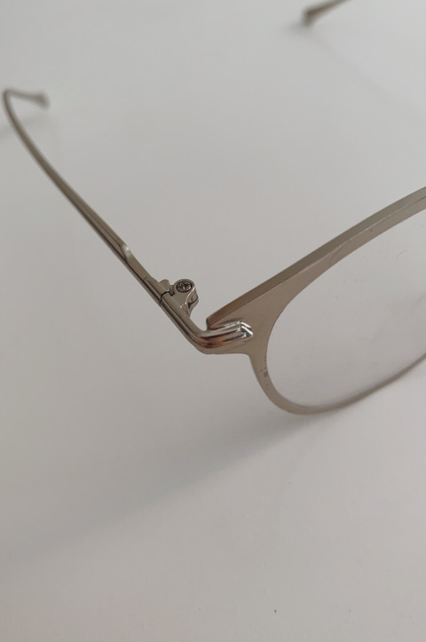 A slim metal oval frame, close.