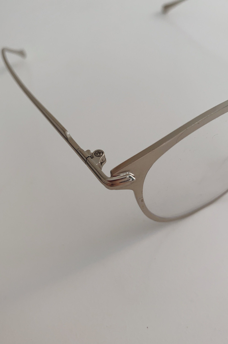 A slim metal oval frame, close.