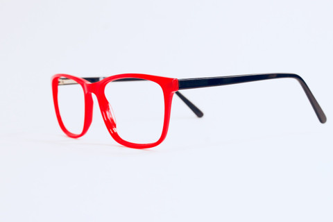 Red frames with navy temples on white.